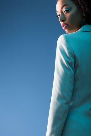 african american woman looking at camera isolated on blue