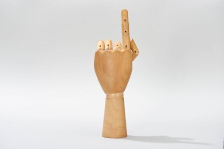 Wooden hand of puppet pointing with finger on grey backgroundの写真素材