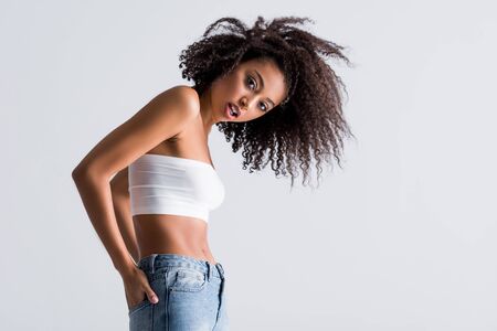 african american woman in white top isolated on greyの写真素材