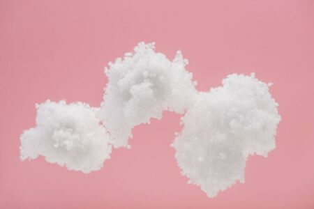 white fluffy clouds made of cotton wool isolated on pink