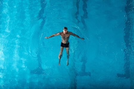 top view of muscular swimmer training in swimming poolの写真素材