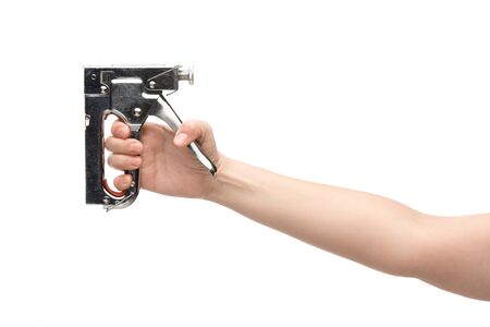 cropped view of woman holding construction stapler isolated on whiteの写真素材