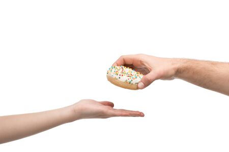 cropped view of man giving donut to woman isolated on whiteの写真素材