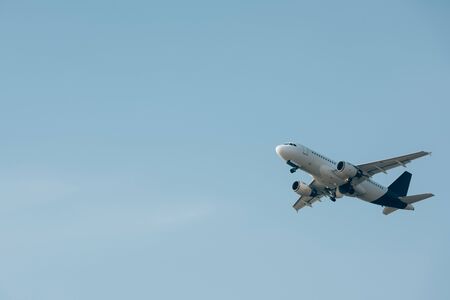 Commercial jet plane landing in blue skyの写真素材