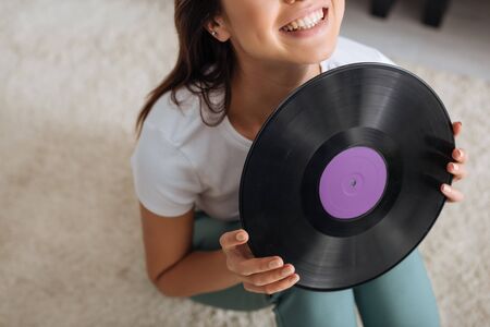 cropped view of happy woman holding retro vinyl recordの写真素材
