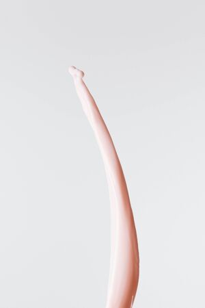 smooth fresh pink milk splash isolated on whiteの写真素材