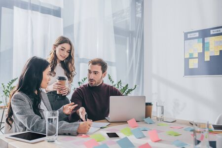 businessman near multicultural businesswoman in office