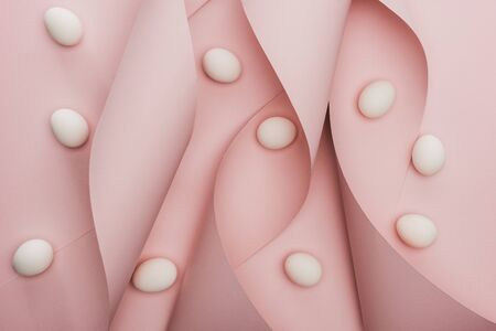 top view of chicken eggs in spiral paper pink swirls