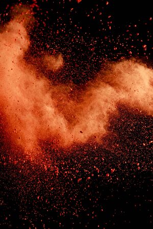 orange colorful holi paint explosion on black backgroundの写真素材
