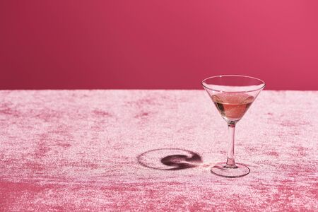 rose wine in glass on velour pink cloth isolated on pink, girlish conceptの写真素材