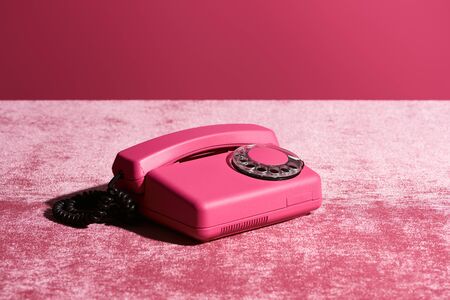 vintage phone on velour pink cloth isolated on pink, girlish conceptの写真素材