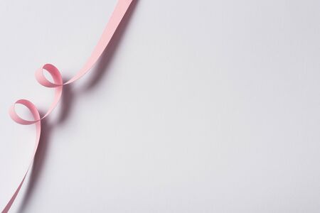 top view of pink paper swirl on white backgroundの写真素材