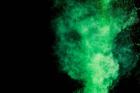 green colorful holi paint explosion on black background