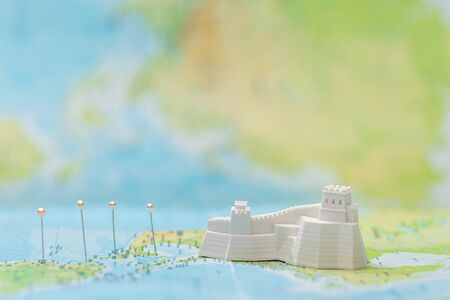 small figurine with great wall near pins on mapの写真素材