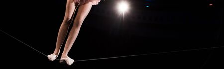 panoramic shot of acrobat standing on ropeの写真素材