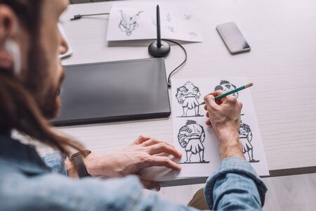 selective focus of illustrator drawing cartoon sketches