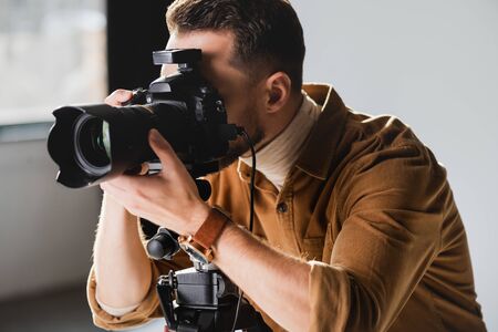 photographer taking photo with digital camera on backstageの写真素材
