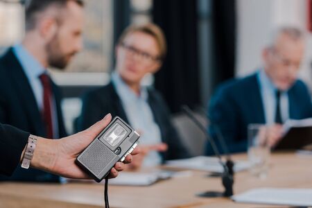 selective focus of journalist holding voice recorder near diplomatsの写真素材