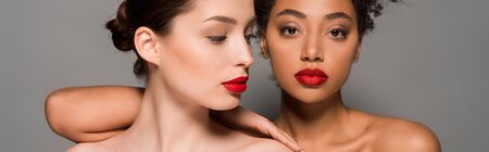panoramic shot of attractive nude multiracial girls with red lips, isolated on greyの写真素材
