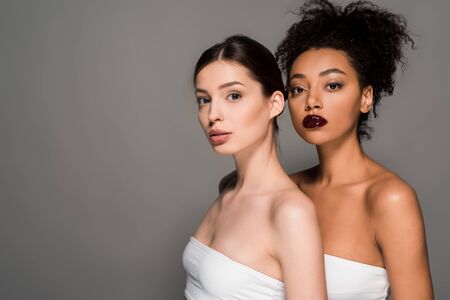 portrait of multicultural young women with perfect skin, isolated on grey
