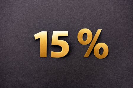 top view of golden 15 percent signs on black background