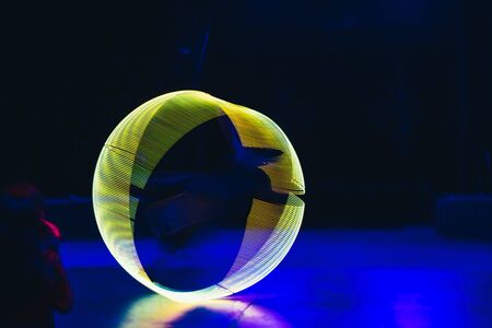Green neon light in circle shape on dark background
