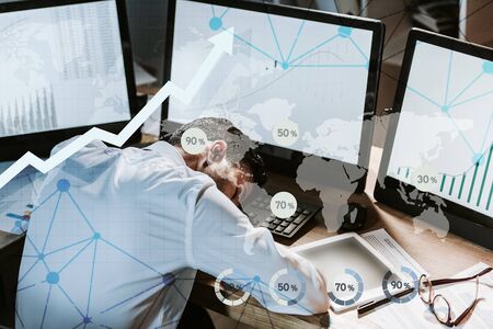 tired bi-racial trader sleeping near computers with graphs