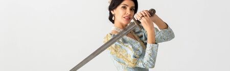 panoramic shot of smiling queen holding sword isolated on greyの写真素材