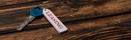 panoramic shot of key with leasing lettering on wooden surfaceの写真素材