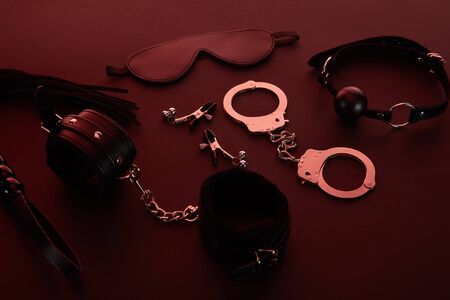 sex toys in dark lighting on red backgroundの写真素材