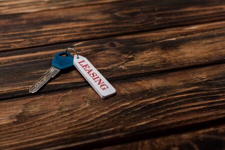 key with leasing lettering on wooden surfaceの写真素材