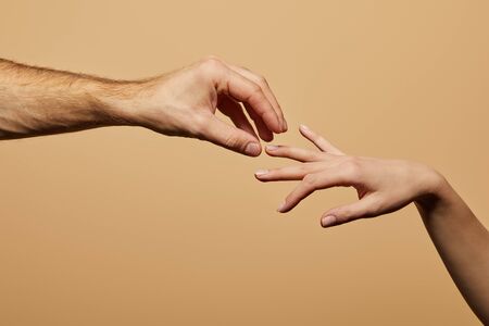 cropped view of man doing marriage proposal to woman isolated on beigeの写真素材