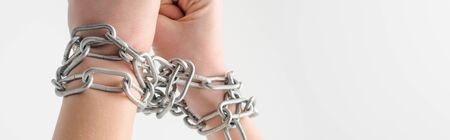 panoramic shot of woman in metallic chains isolated on white, human rights conceptの写真素材