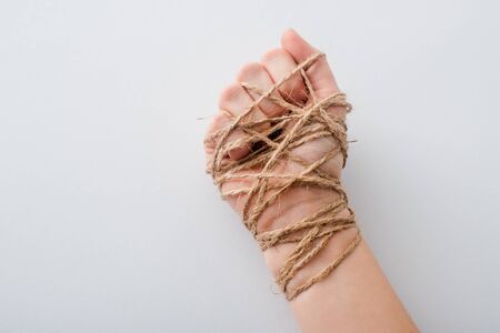 cropped view of girl with tied hand isolated on white, human rights concept