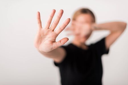 selective focus of woman showing stop gesture isolated on white