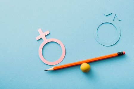 small ball and pencil with different genders isolated on blue, sexual equality concept