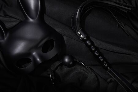 top view of sex toys on black textile background