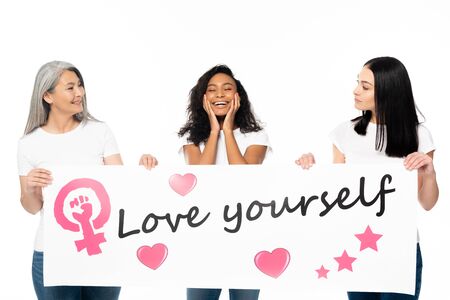 multicultural women holding placard with love yourself lettering isolated on whiteの写真素材