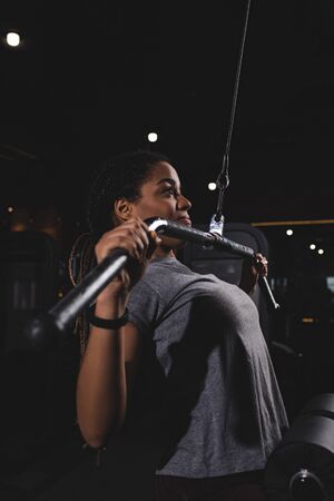 side view of young african american girl training in gym