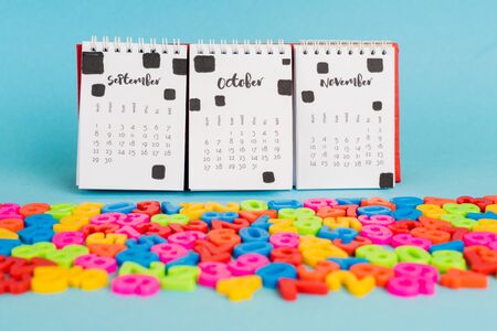 Calendar and colorful plastic numbers on blue backgroundの写真素材