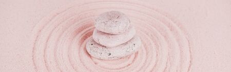 Panoramic shot of zen stones on pink sand with circlesの写真素材