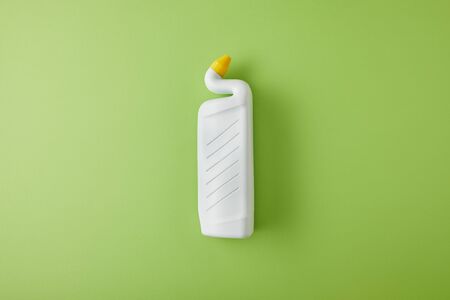 top view of white bottle with toilet cleaner on green