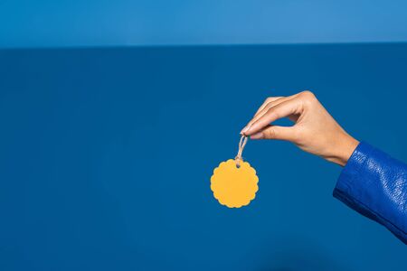 cropped view of african american woman holding blank label on blue background
