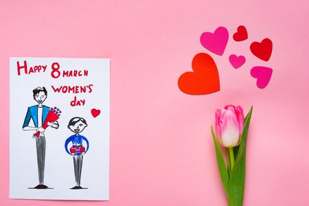 Top view of greeting card with drawing and 8 march happy womens day lettering and tulip with paper...