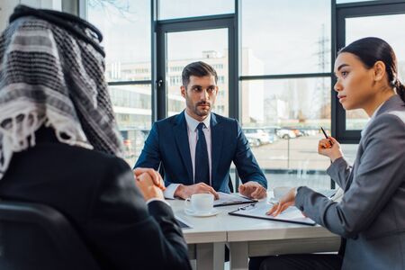 multicultural business partners talking on meeting with translator in officeの写真素材