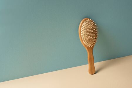 Wooden hair brush on beige and grey, zero waste conceptの写真素材