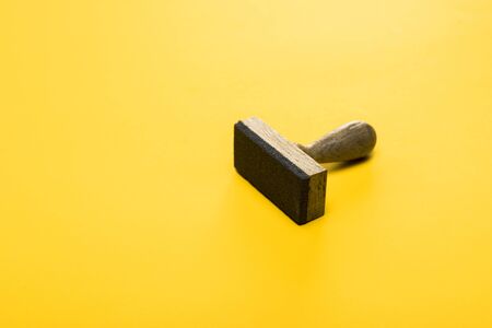 wooden stamp on yellow, quality conceptの写真素材