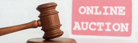 panoramic shot of gavel and card with online auction letteringの写真素材