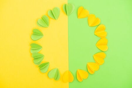 Top view of decorative hearts on yellow and green background, spring conceptの写真素材