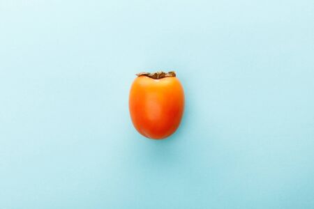 Top view of persimmon on blue backgroundの写真素材